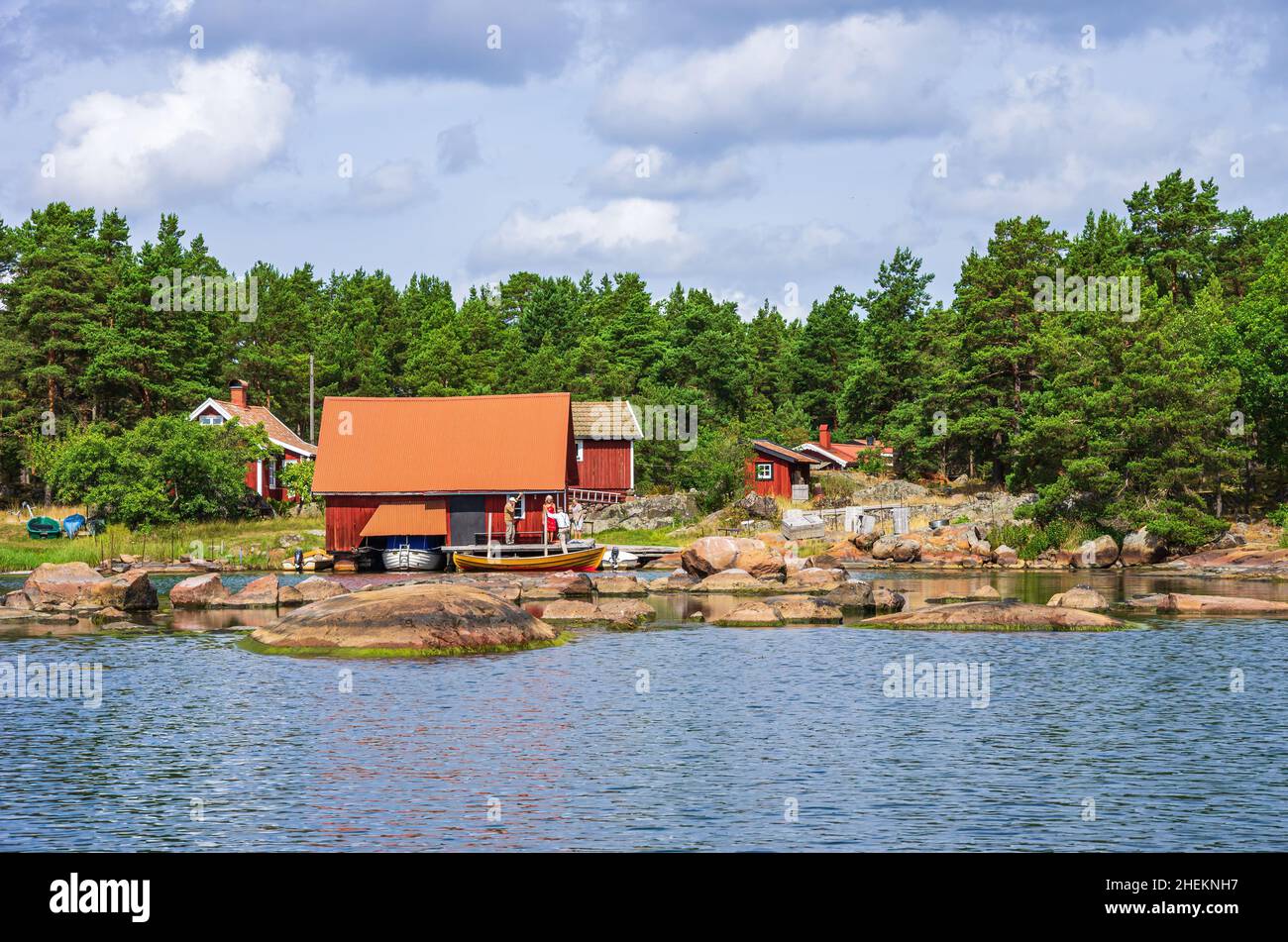 Paesaggio pittoresco con capanne a mare e cottage in legno in tipico rosso svedese ai margini dell'arcipelago di Småland vicino Oskarshamn, Svezia. Foto Stock