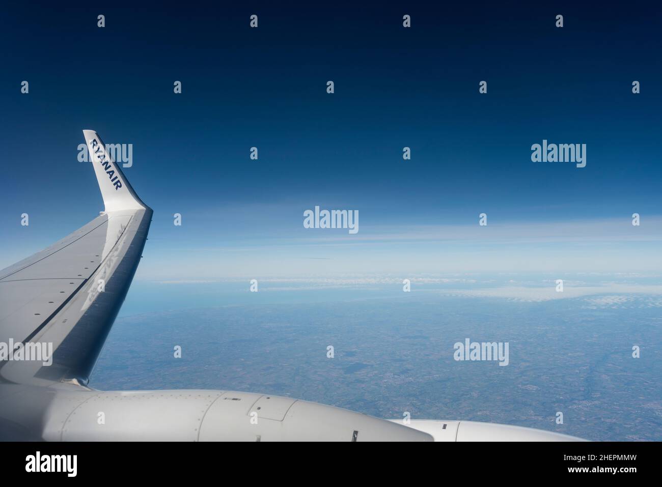 Wingtip di un Boeing Ryanair 737 che vola ad alta quota di crociera sopra la Francia, con cielo blu profondo. Titoli Ryanair su wing punta alare, su nuvola leggera Foto Stock