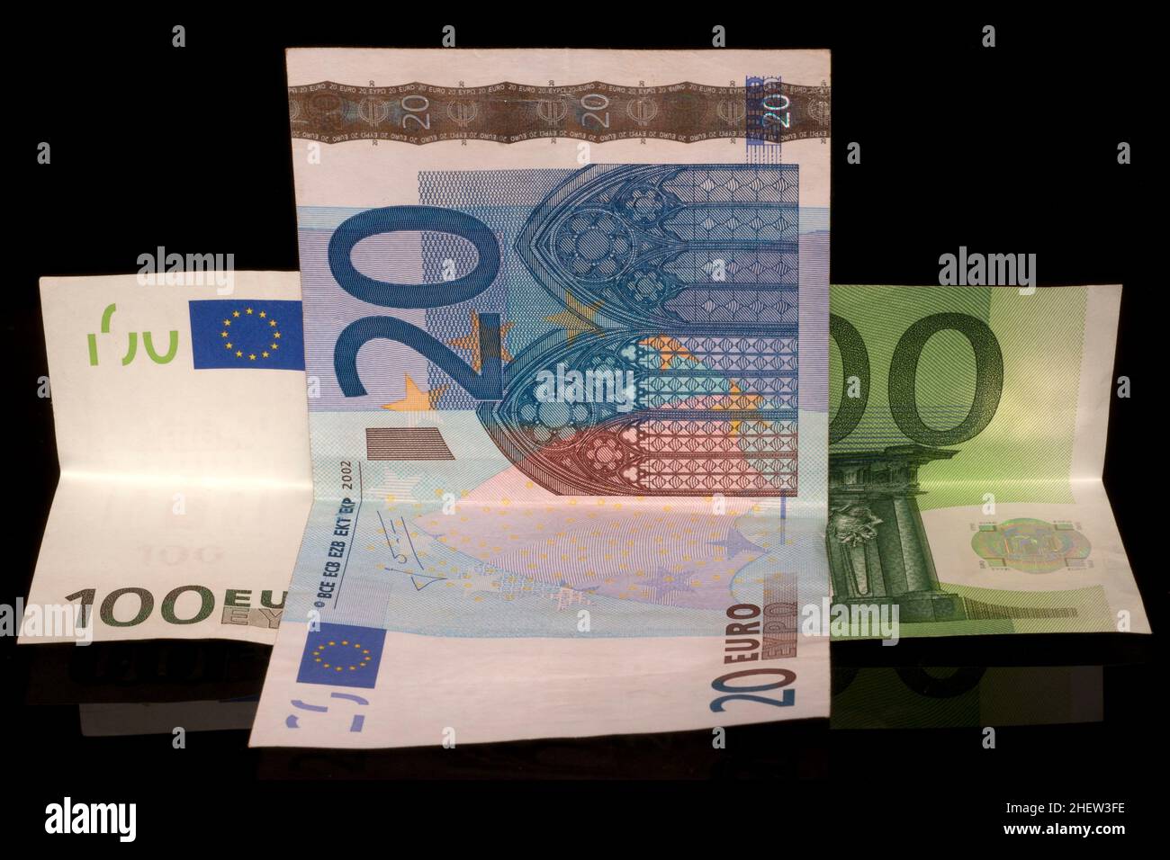 Soldi per niente, 20 e 100 euro su sfondo nero Foto Stock