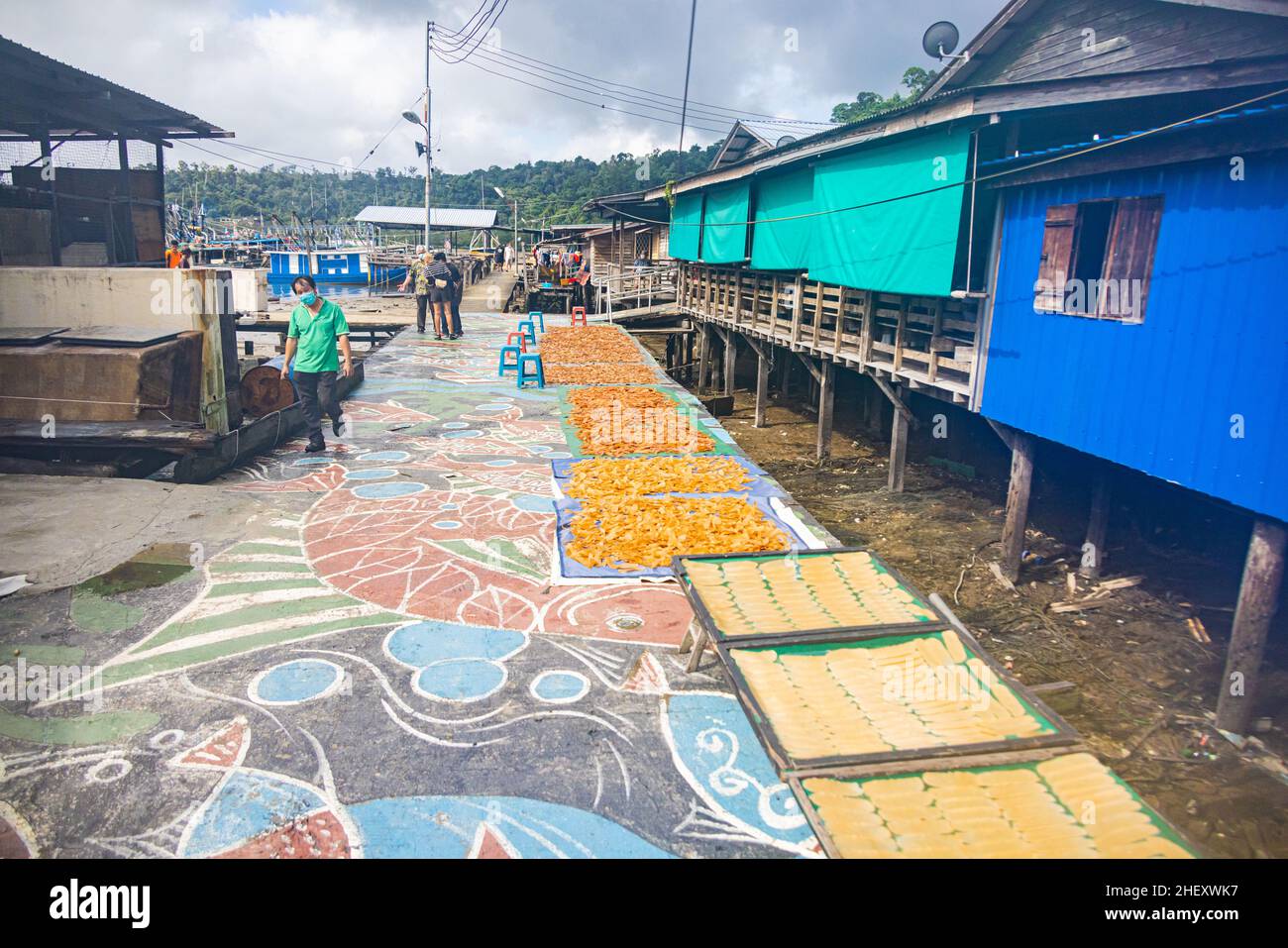 Sandakan, Malesia - 06 gennaio 2022: Villaggio Fisher man vicino al centro di Sandakan, Borneo. Il pesce è essiccato sulle tavole del molo nel tropicale Foto Stock