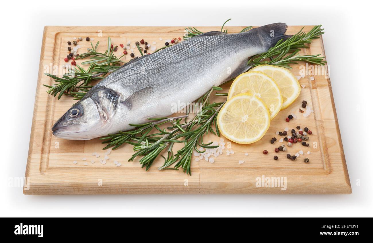 Pesce fresco non cotti con limone e rosmarino su tavola di legno su sfondo bianco con percorso di ritaglio Foto Stock