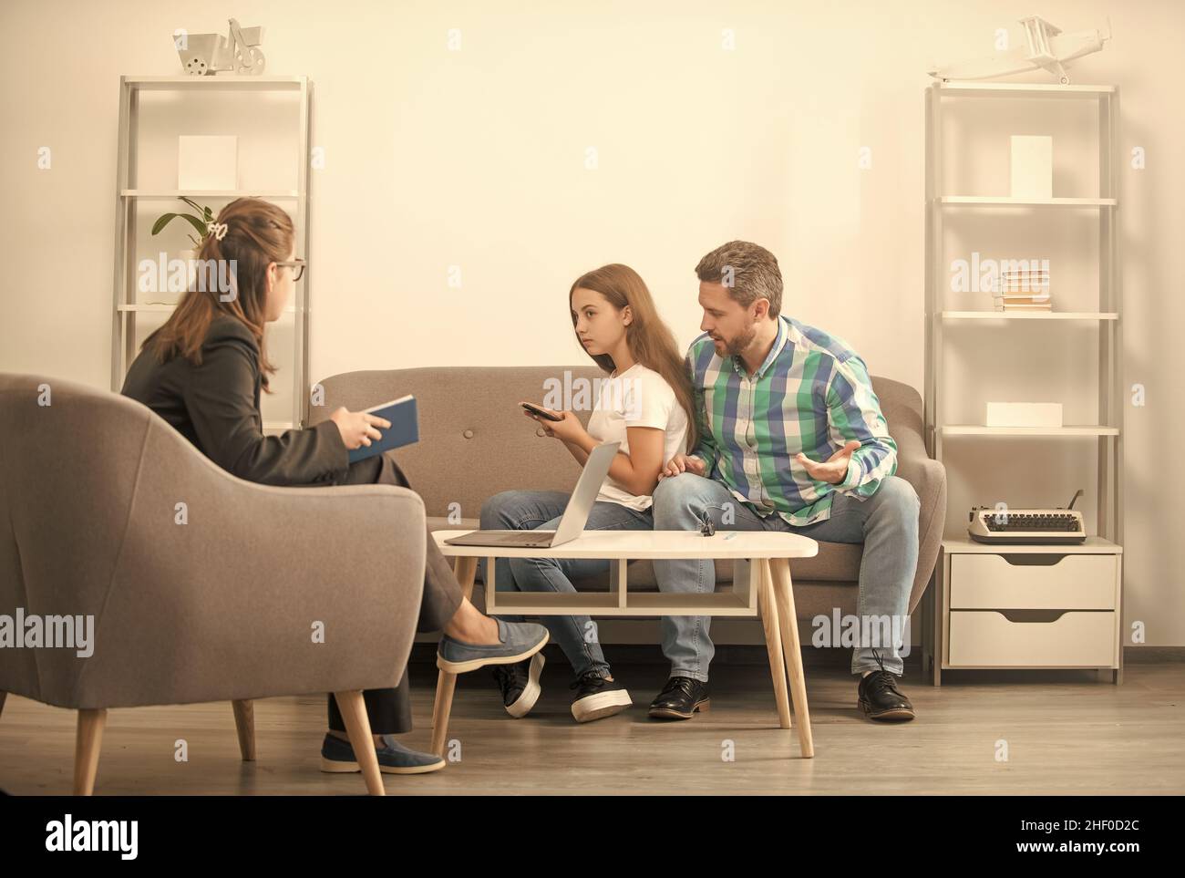 dipendenza telefonica. padre e bambino alla sessione psicologa. terapia familiare. Foto Stock