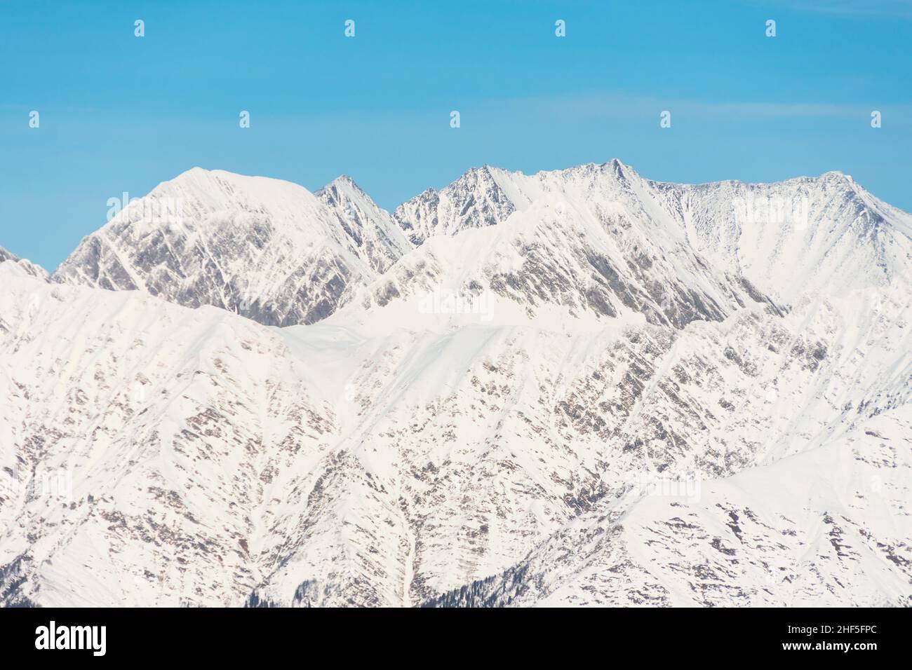 Paesaggio innevato di montagna, catena montuosa passare cielo blu Foto Stock