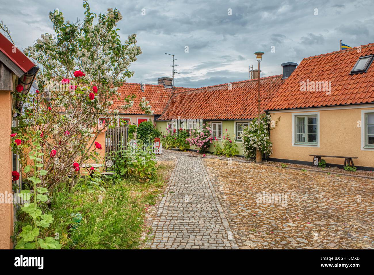 La piazza acciottolata in un piccolo villaggio turistico di pescatori nella regione di Osterlen mostra un quartiere accogliente e trasmette un senso di comunità. Svezia Foto Stock