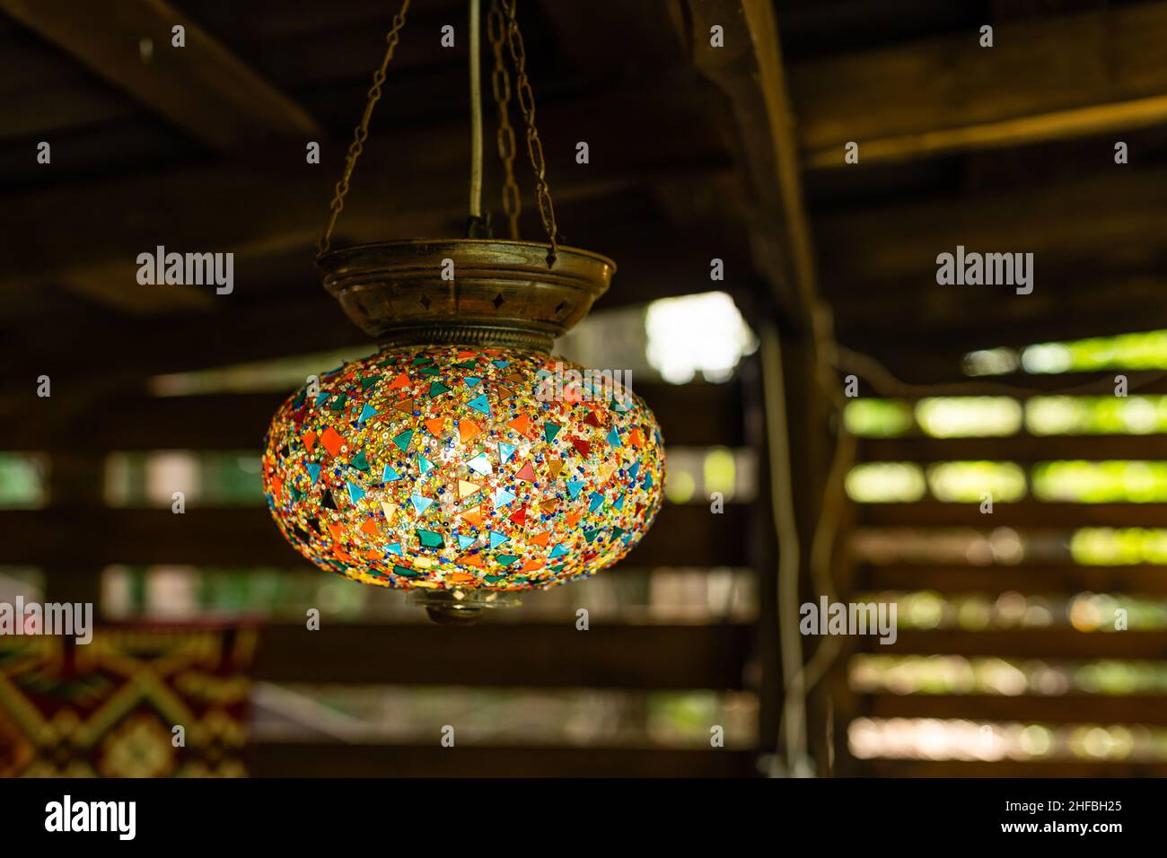 Lampade appese al soffitto, lampada rotonda a mosaico in interni in legno. Foto Stock