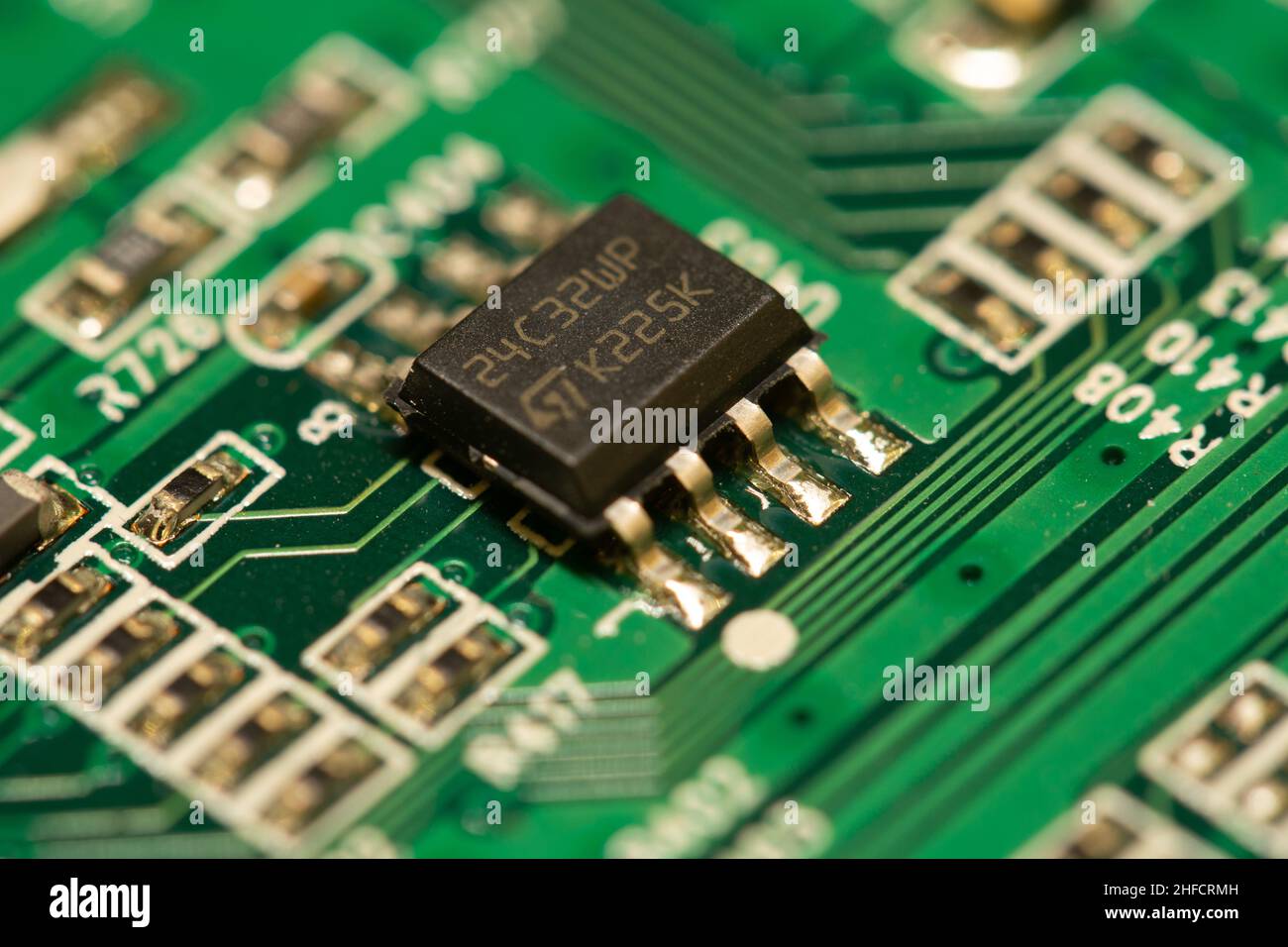 Microchip saldato su una scheda a circuito stampato (PCB) verde. Foto Stock