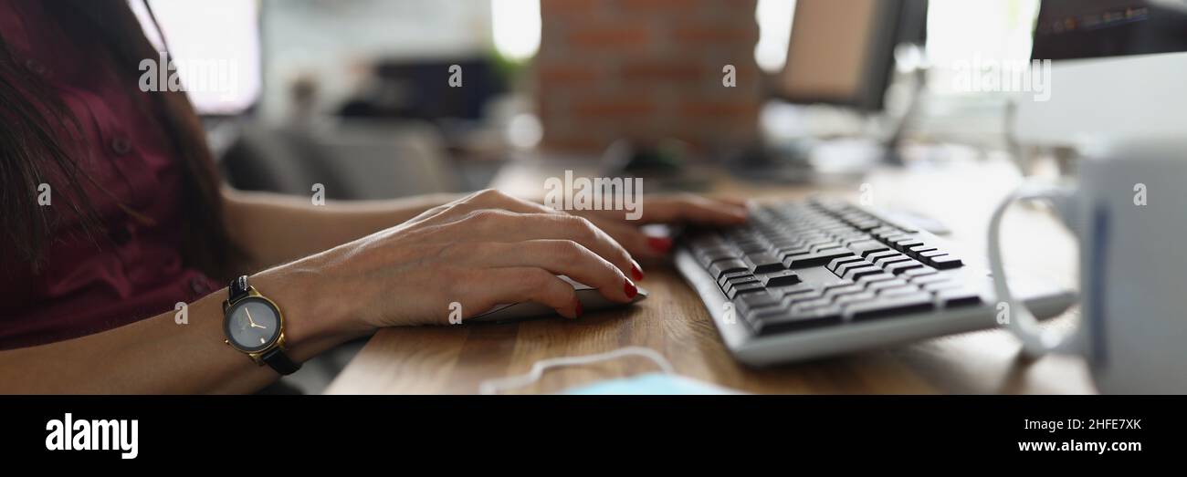 Le mani femminili con un orologio premono la tastiera Foto Stock