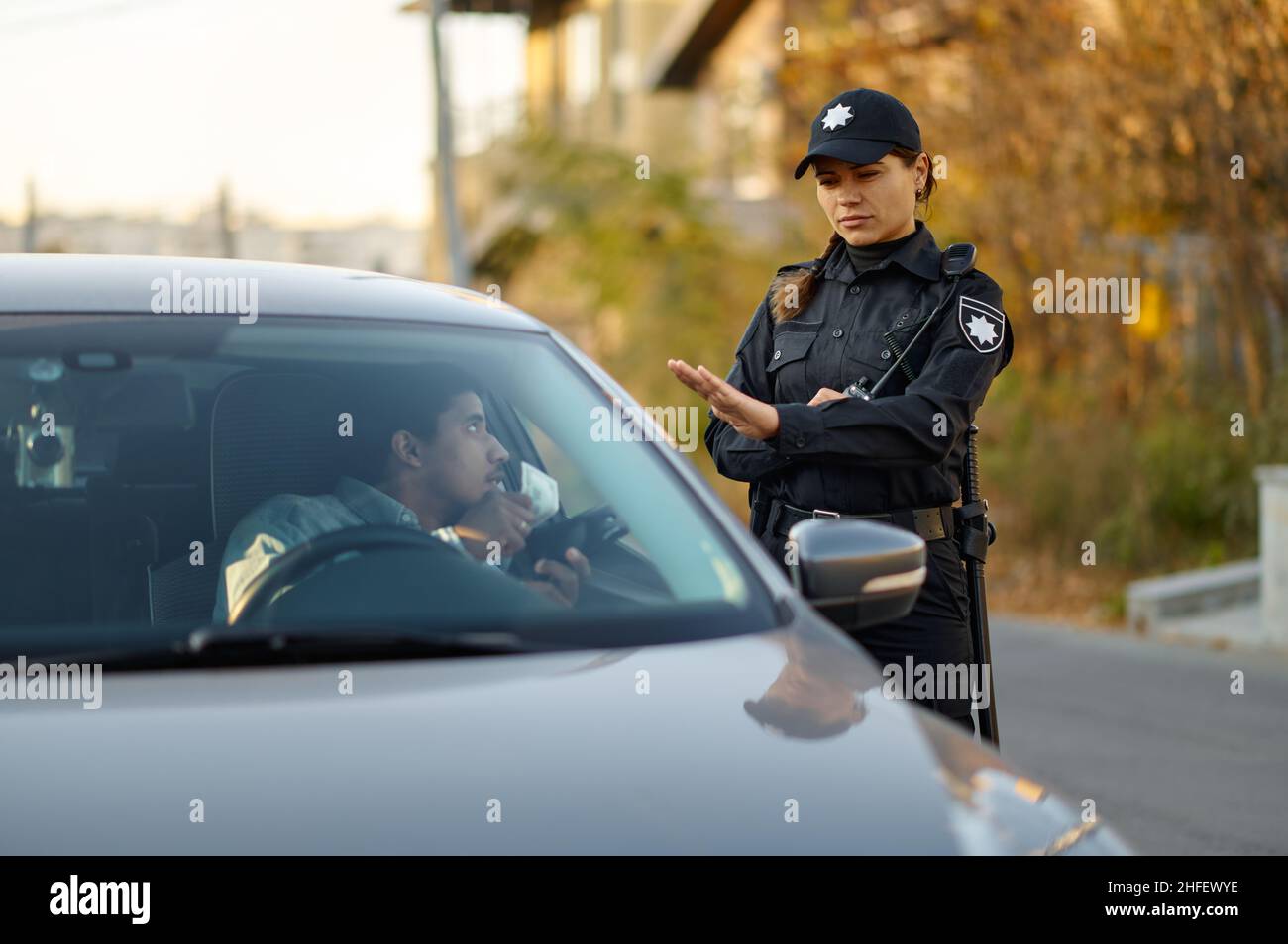 L'ufficiale di polizia femminile rifiuta la tangente dal conducente Foto Stock