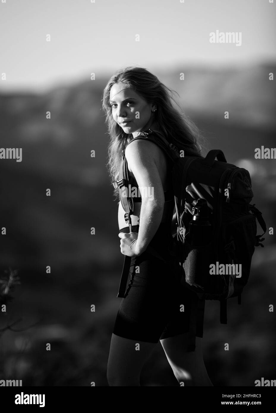 Donna viaggiatore che guarda al vulcano Batur. Indonesia. Donna escursionista con zaino in montagna. Ragazza che camminano una collina in un punto panoramico. Backpacking turismo Foto Stock