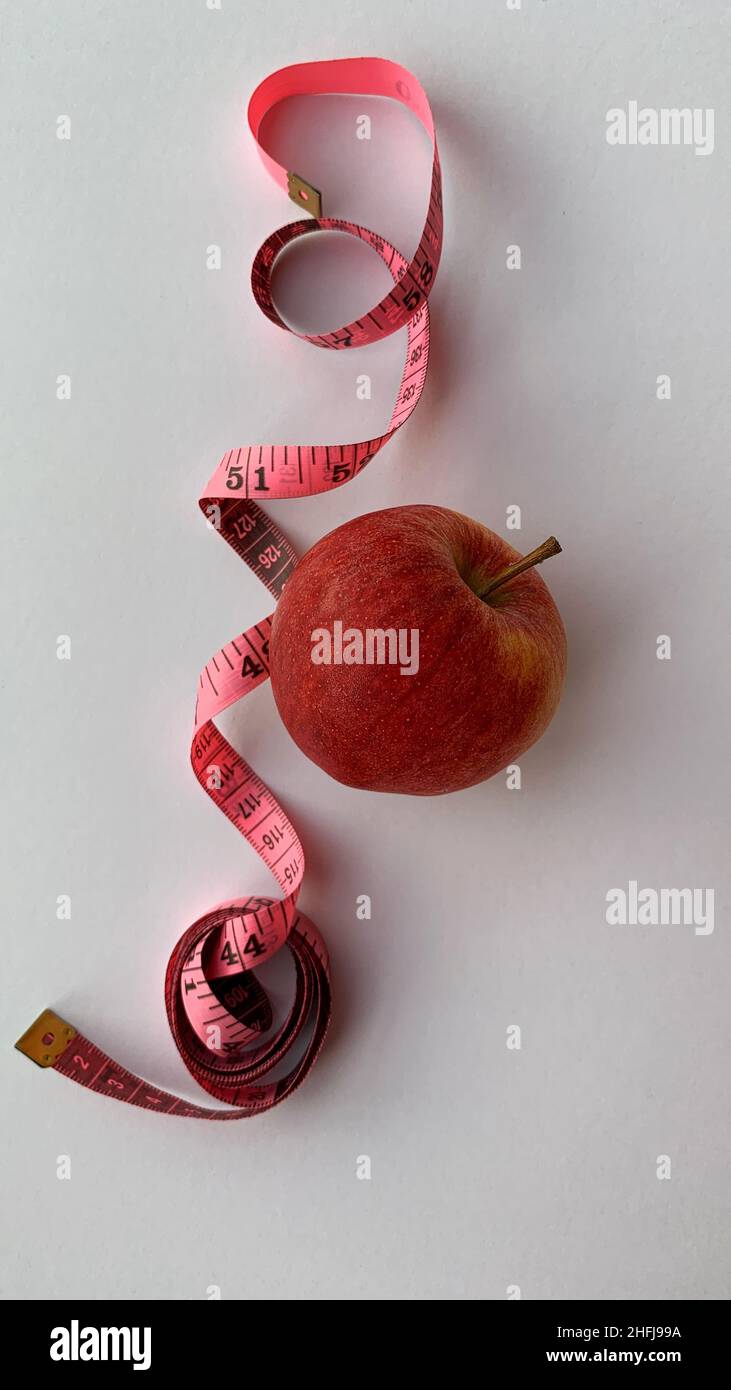 Dieta e sano perdita di vita peso sottile concetto. La mela rossa organica e la scala del peso misurano lo sfondo del rubinetto. Vista dall'alto. Foto Stock