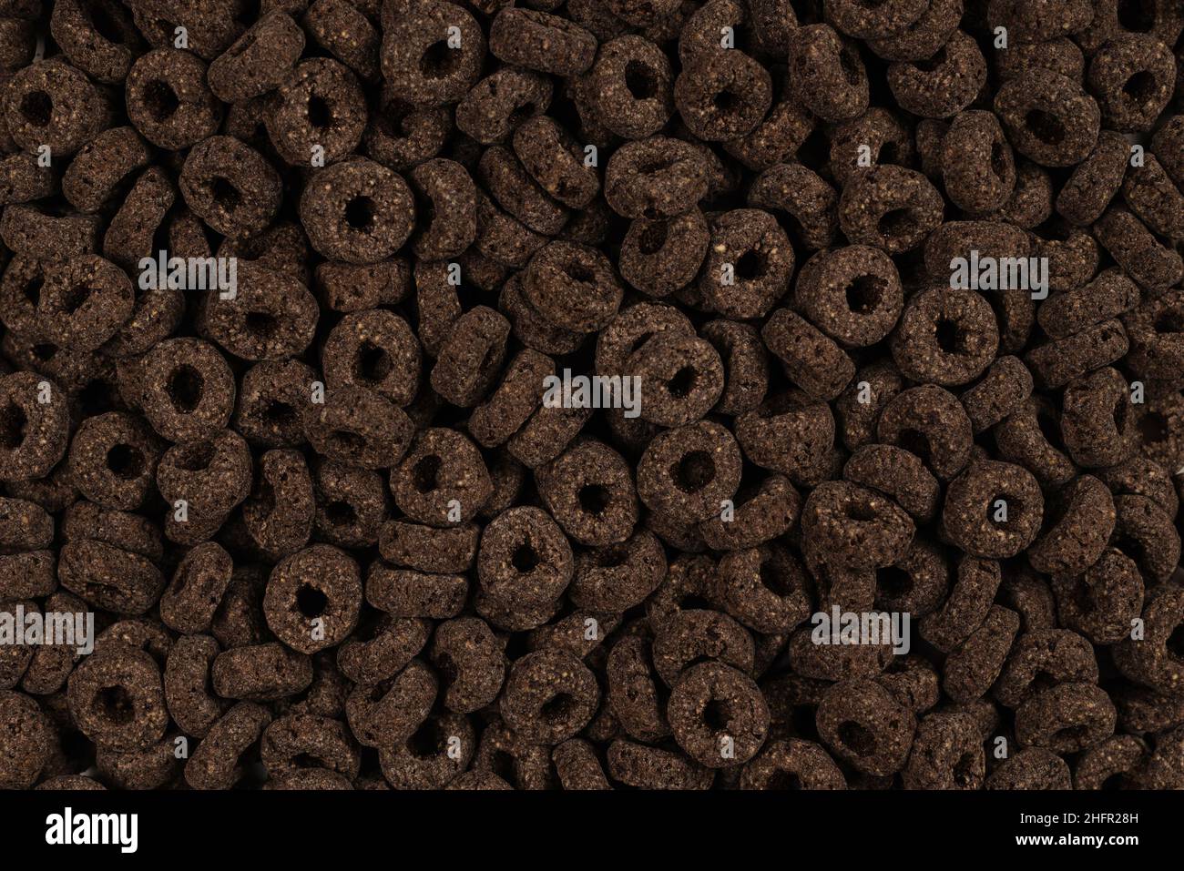 Sfondo e texture corn-flakes. Anelli di cioccolato. Foto Stock
