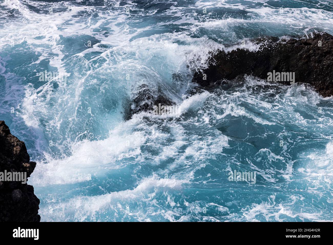 Mari accidentati che si aggirano sulle rocce vulcaniche della costa di Playa San Juan, Tenerife, Isole Canarie, Spagna Foto Stock