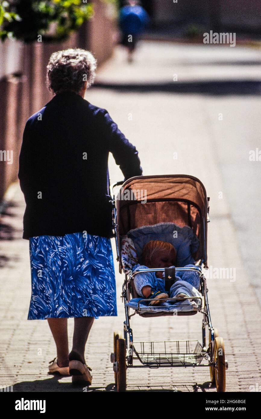 Nonna che cammina con baby carrier, Stoccolma 1970 Foto Stock
