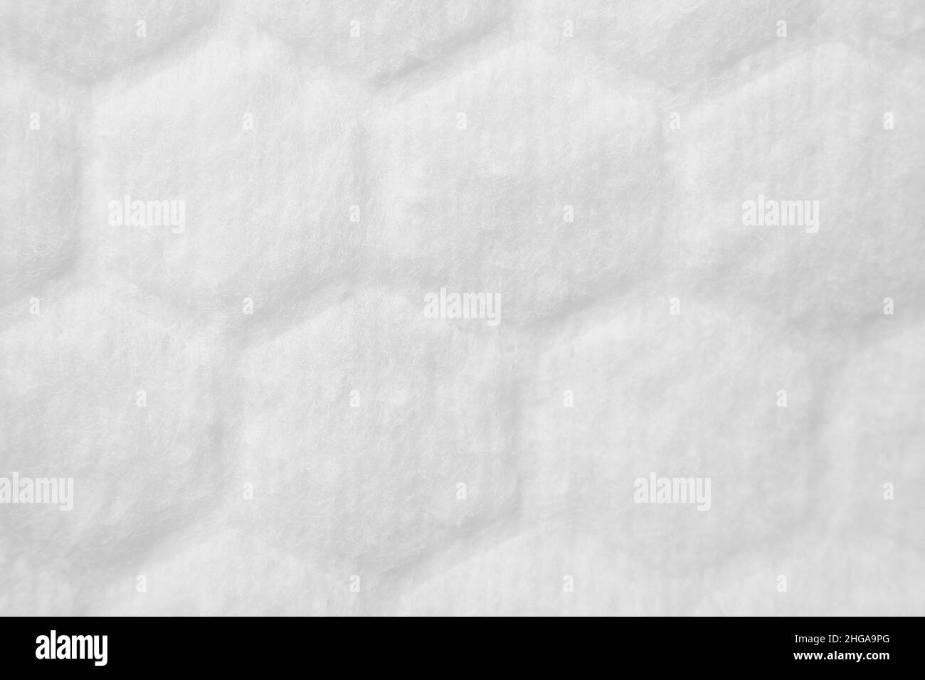 Si tratta di tessuto bianco bianco bianco bianco bianco bianco con texture di nido d'ape o cells.The superficie di cotone pad close-up. Sfondo astratto. Foto Stock