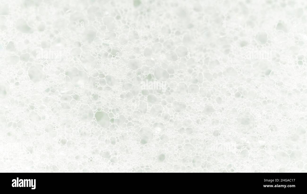 Schiuma bianca con piccole bolle macro fotografia. Schiuma di sapone in alta risoluzione. Bolle di sapone sullo sfondo della superficie dell'acqua con spazio di copia. Foto Stock