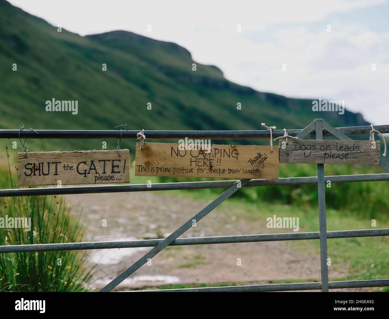 Un cancello fattoria con segnali di avvertimento e avvisi sul percorso fattoria per Talisker Bay spiaggia a Talisker su Skye in Highlands Scozia Regno Unito Foto Stock
