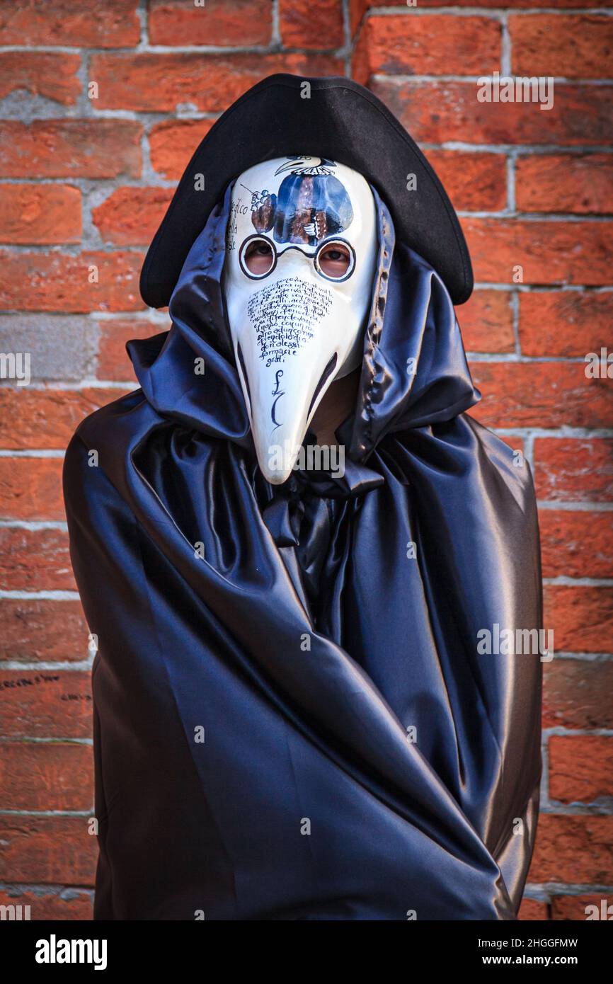 Uomo in costume storico come medico di peste o peste con maschera, cappello, mantello tabarro, Carnevale di Venezia, Carnivale di Venezia, Veneto, Italia Foto Stock