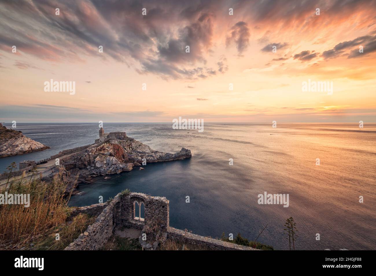 Meraviglioso tramonto pieno di colori a Porto Venere - Italia di fronte alla chiesa che si affaccia sul mare Foto Stock