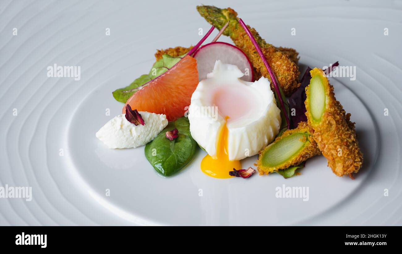 l'alta cucina dello chef, un antipasto gourmet in un ristorante con verdure fresche e uova Foto Stock
