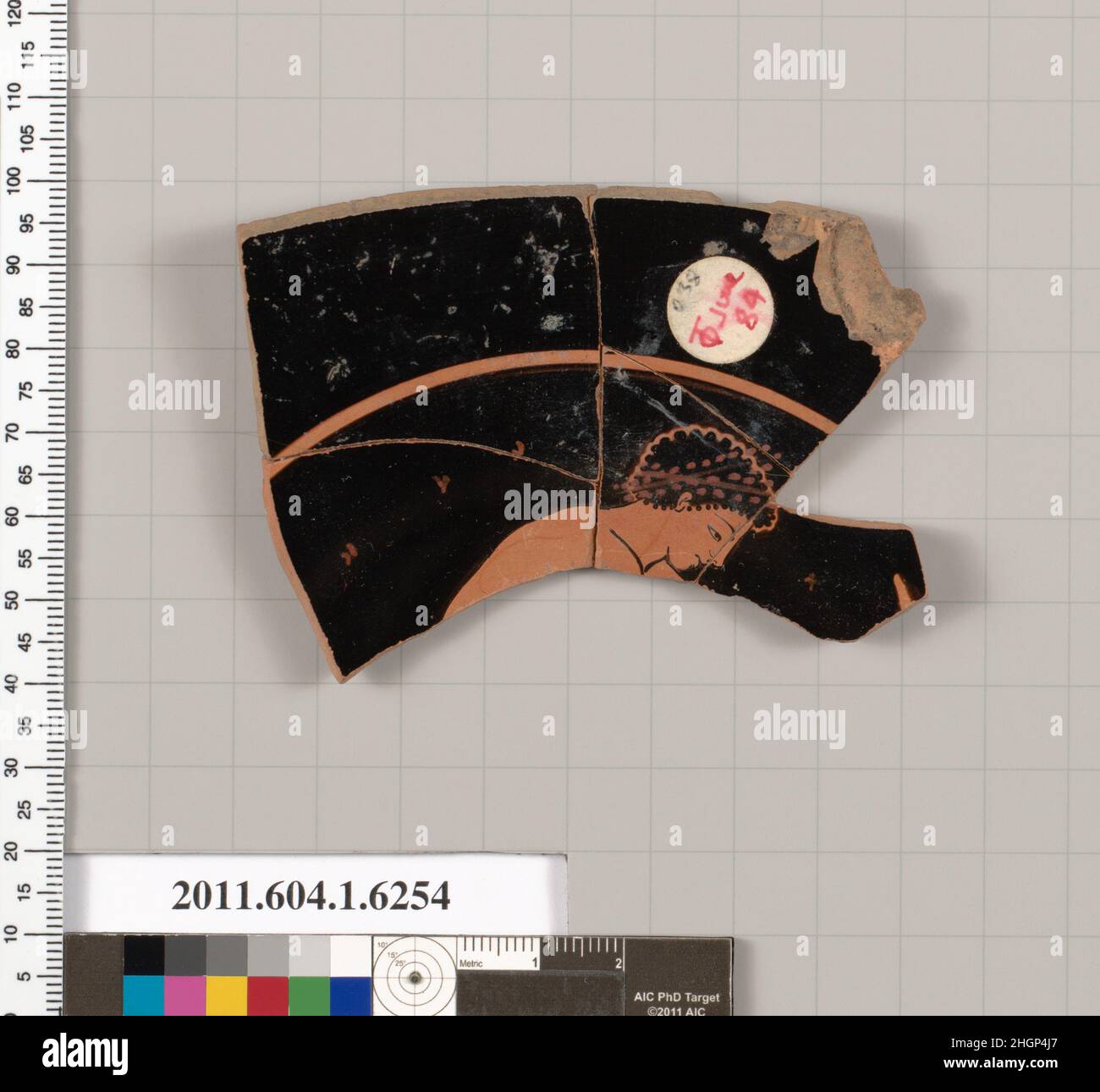 Frammento di terracotta di una kylix (tazza da bere) 500–480 a.C. Greco, Attico interno, testa, collo, spalle, e parte del dorso della giovinezza; quattro lettere di un'iscrizione. Frammento di terracotta di una kylix (tazza da bere) 709510 Foto Stock