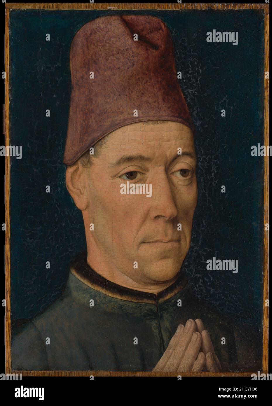 Ritratto di un uomo ca. 1470 bute dieriche i dettagli di Netherlandish attentamente osservati, come la pelle sciolta sotto gli occhi e le pieghe della bocca e delle sopracciglia, creano un aspetto di earnestness che è caratteristico del lavoro di bute. Il pannello è stato tagliato su tutti i lati; non è chiaro se si tratta di un ritratto indipendente, o se una volta faceva parte di un trittico religioso o di una composizione più grande. Il cappello è una caratteristica insolita per una figura devozionale, anche se le mani sono unite in un gesto di preghiera. Sono stati dipinti sopra la giacca dell'uomo, e con il tempo, questo ha portato in un leggero Foto Stock