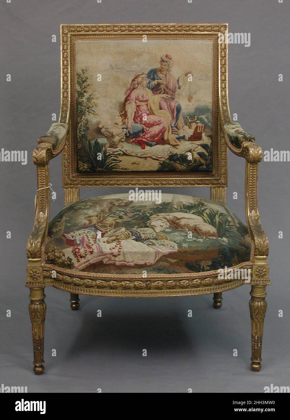 Poltrona progettata ca. 1786, tessuto 1790–91; telaio della sedia seconda metà 19th secolo tappezzeria arazzi di Beauvais commissionato da Luigi XVI, questo insieme appartiene ad un insieme di quattro appendiabiti da parete (1978.404.1–.4) e cinquantasei pezzi di tappezzeria di mobili (1978.404.5a–c–.18a–c) raffiguranti i quattro continenti: America, Europa, Asia e Africa. Poltrona 231938 Foto Stock