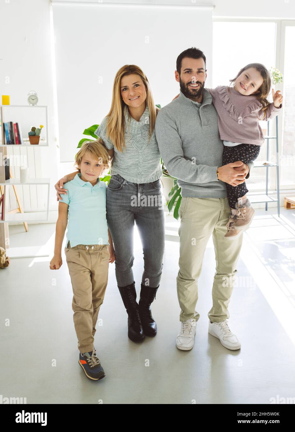 Genitori sorridenti con bambini a casa Foto Stock