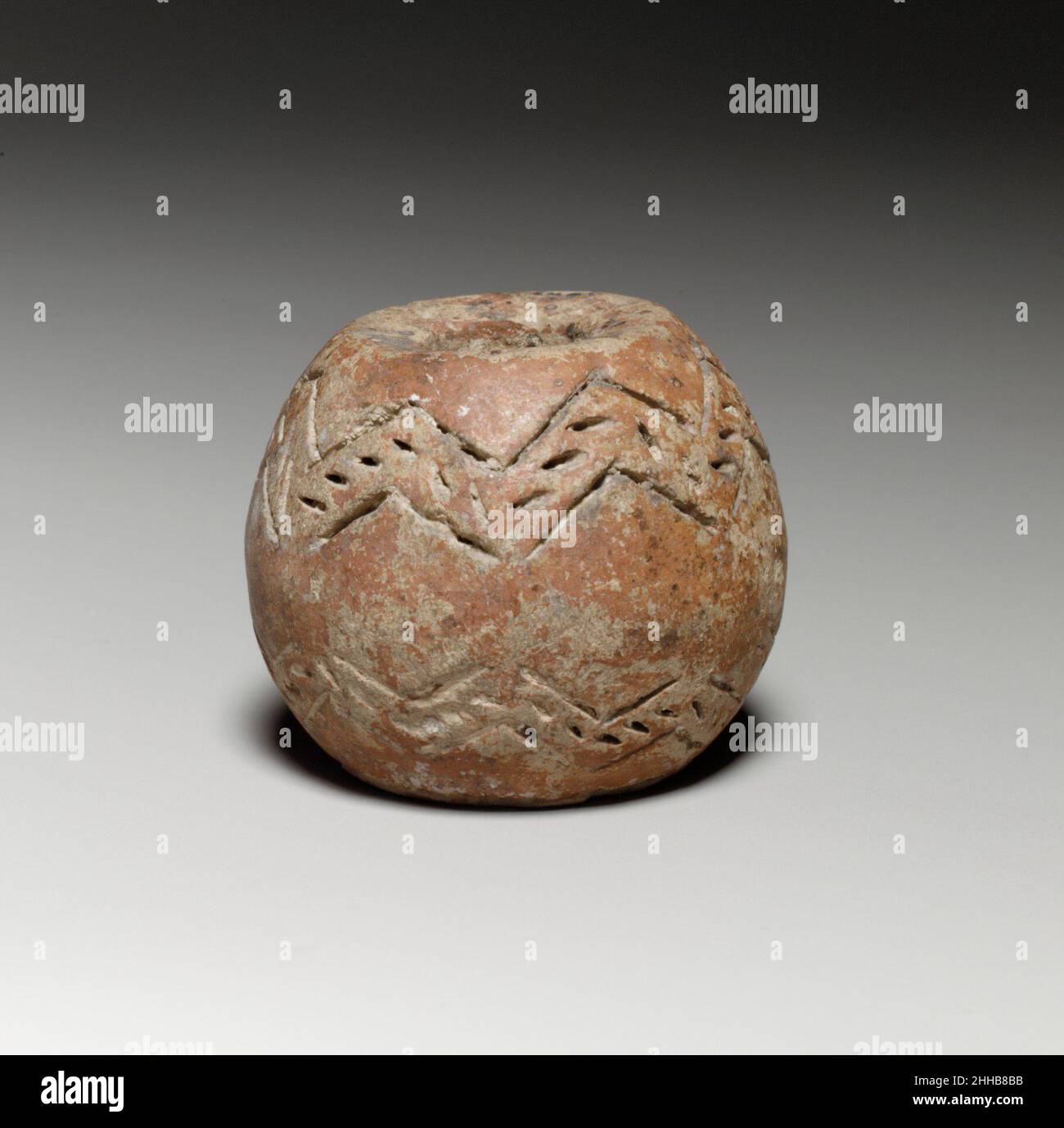 Perno sferico con testa piatta larga e base ca. 2000–1725 a.C. i fuselli ciprioti hanno contribuito alla realizzazione di stoffe per indumenti e biancheria da letto. Sono stati posti in tombe, forse in modo che il defunto potrebbe continuare a girare la lana nell'aldilà. Perno sferico con testa piana larga e base 240523 Foto Stock