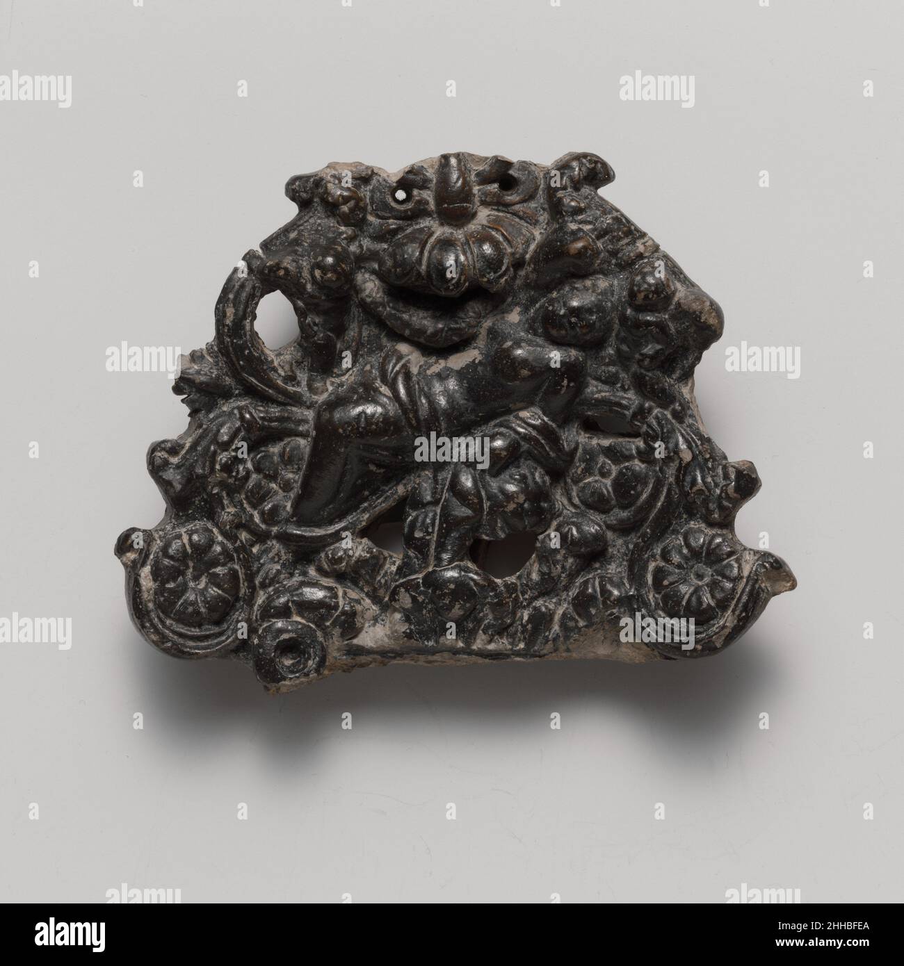 Manico in terracotta 1st secolo a.C. romana il manico, da un grande piatto da portata, è riccamente decorato con piccoli pidi e una figura femminile reclinabile, probabilmente Venere (Afrodite). Manico in terracotta. Romana. 1st secolo a.C. Terracotta; vetreria nera. Vasi Foto Stock