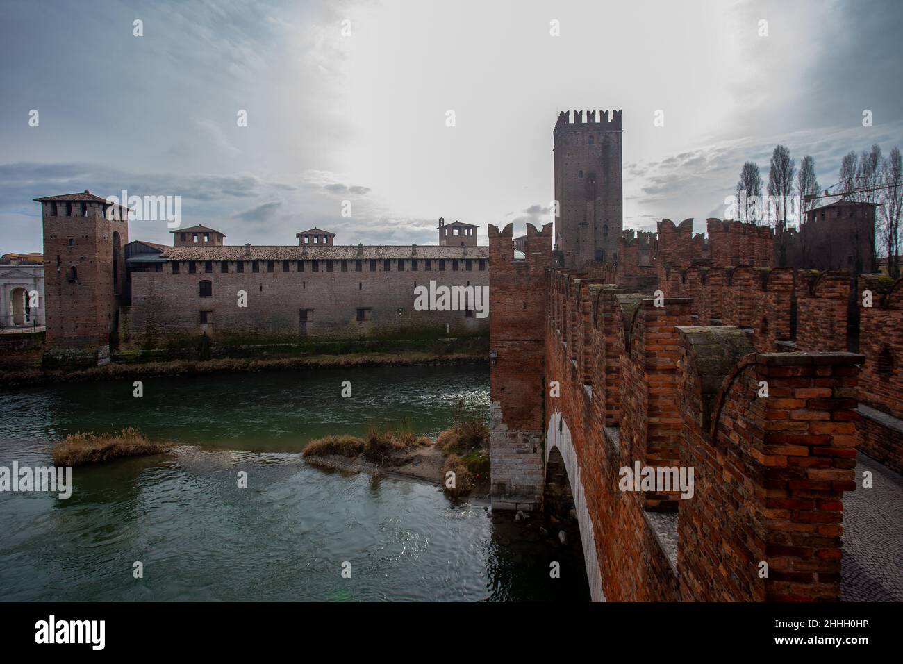 Il Ponte di Castelvecchio e i famosi merli (simili sul Cremlino di Mosca) e il Museo di Castelvecchio. Fiume Adige e cielo di sole a Verona Foto Stock