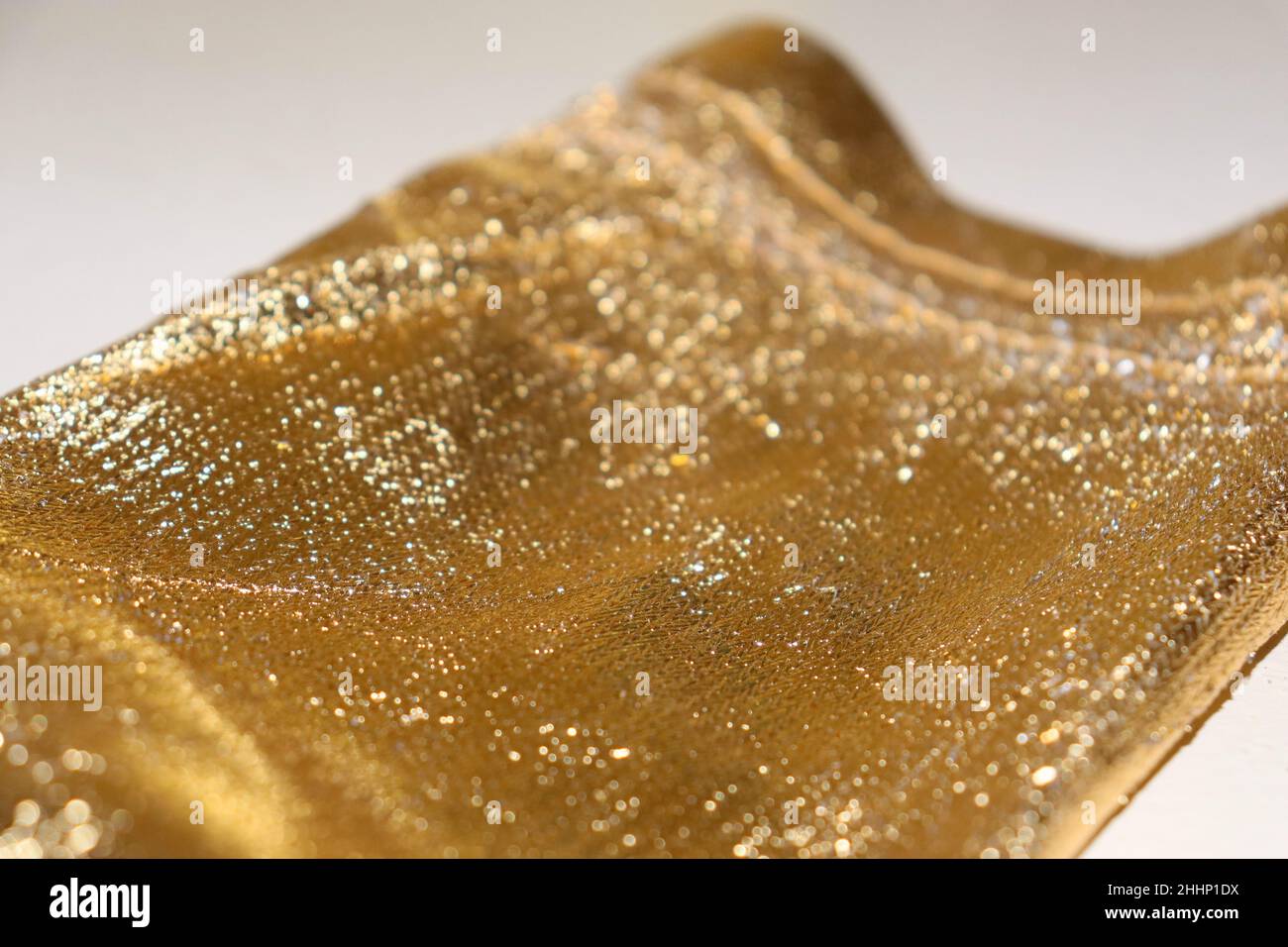 Festa Speciale occasione piccola borsa a stracci in oro con luccicanti scintille luccicanti Closeup Texture background Foto Stock