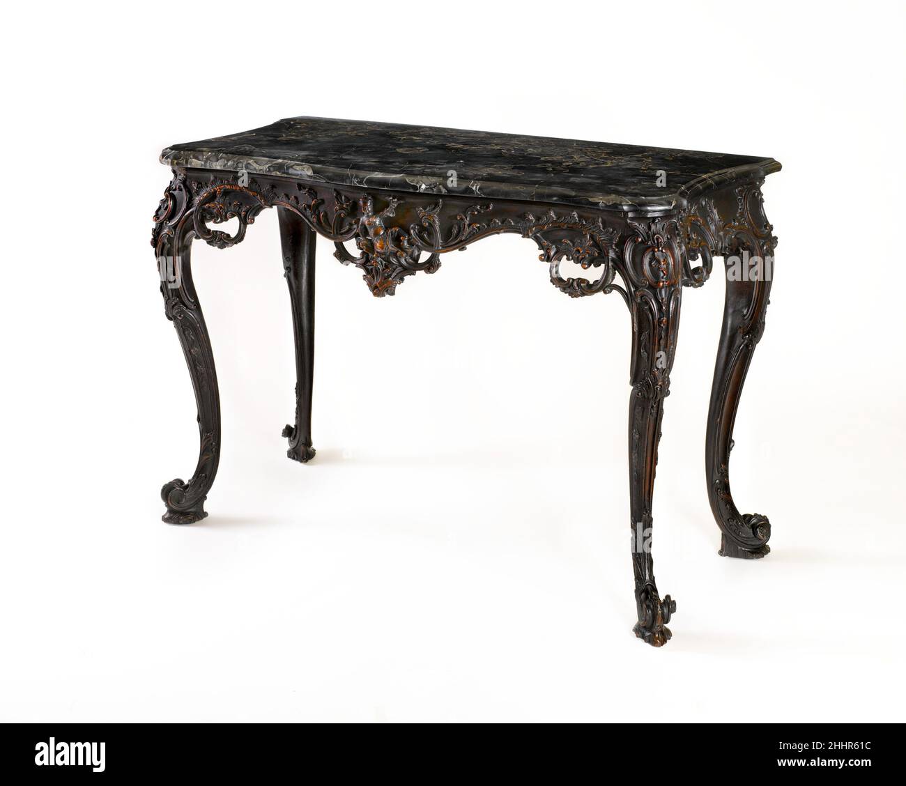 Marble-Slab table 1765–70 American questa è probabilmente una delle due “lastre di marmo” acquistate dal generale John Cadwalader (1742–1786) ad un'asta nel 1769 per l'uso nella sua casa su Second Street, che ha arredato con un ornamento senza pari altrove a Filadelfia. Nella loro plasticità, le curve a serpentina ininterrotte delle gambe e del bordo sono pienamente nello spirito del francese rococò. Tuttavia, la brillante scultura naturalistica è puramente inglese, probabilmente il lavoro di un carver londinese appena arrivato a Filadelfia.. Tavolo in marmo 5624 Foto Stock