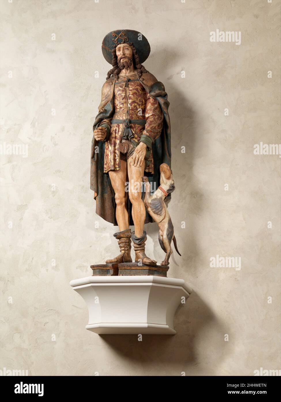 Saint Roch inizio 16th secolo la celebrità francese di Saint Roch deriva dalla sua reputazione per curare le vittime della peste, essendo stato miracolosamente guarito della malattia. La sua rappresentazione qui è in linea con la sua leggenda: Il ricco nativo di Montpellier indossa abiti riccamente colorati e modellati d'oro, e anche il cappello a larga sposa di un pellegrino religioso lungo il tragitto per Roma (simboleggiato dalle chiavi incrociate). Sulla coscia si trova una piaga bulbosa aperta indicativa della peste. Al suo fianco c'è il cane fedele che ha aiutato ad infermiera il santo di nuovo alla salute portandolo il pane e leccandolo così Foto Stock