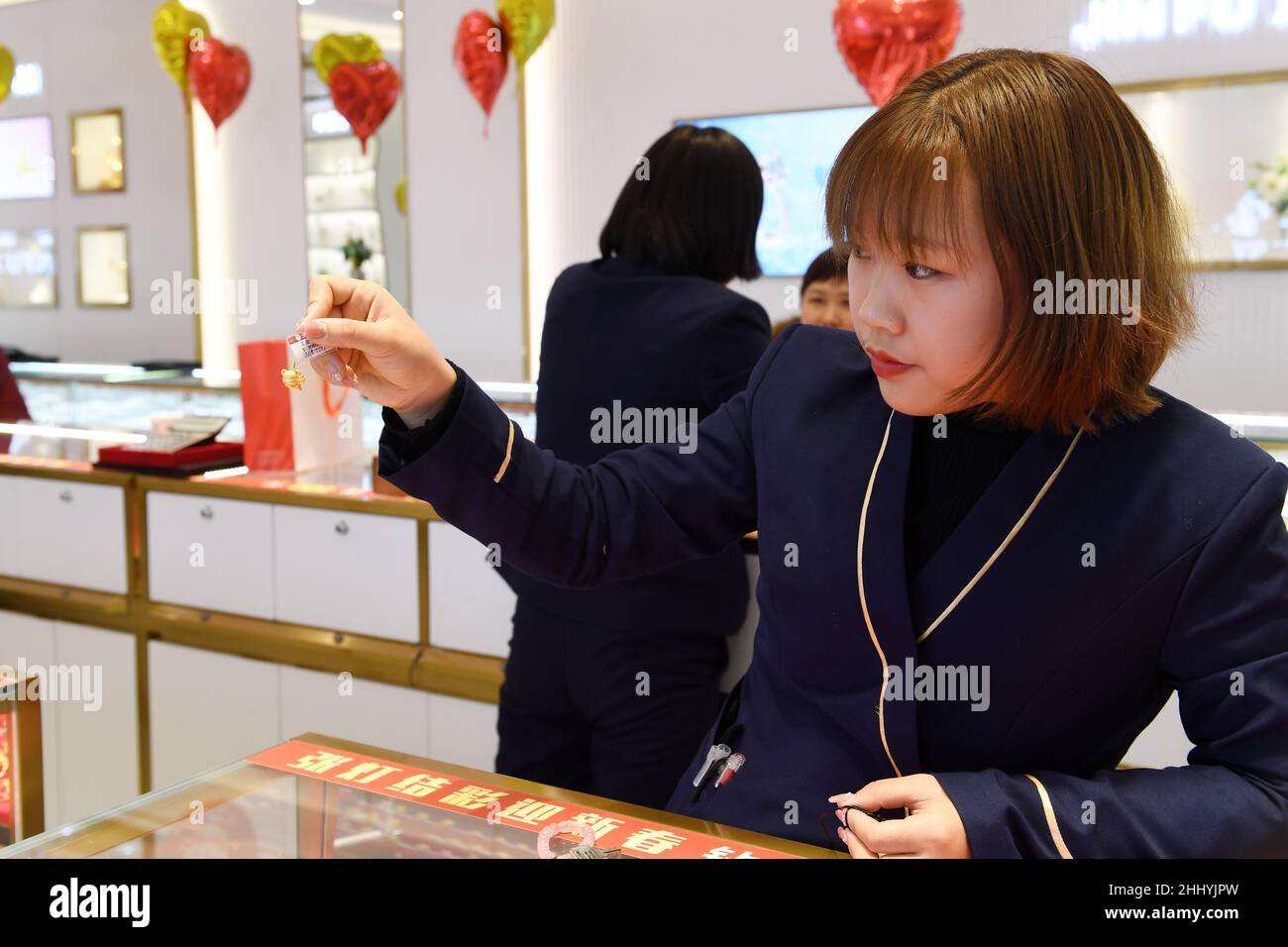 RENHUAI, CINA - 26 GENNAIO 2022 - Un membro dello staff mostra gioielli d'oro dello zodiaco cinese nell'anno della Tigre in un negozio nella città di Renhuai, Sud Foto Stock