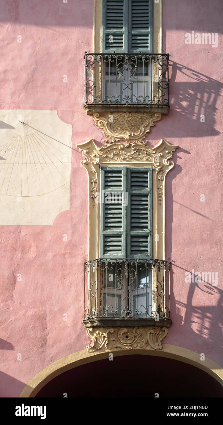 Porta balcone con persiane in legno su una casa rosa in Italia Foto Stock