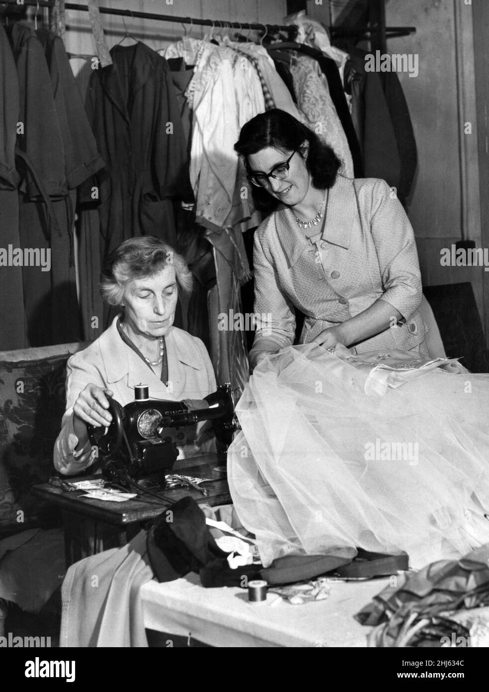 Miss Marion Agar, padrona del guardaroba (a destra) aiuta Mrs May Finch, il comò, a mettere i ritocchi finali ad uno degli abiti d'epoca da utilizzare in 'Candida' presso il Liverpool Playhouse. 20th ottobre 1960. Foto Stock