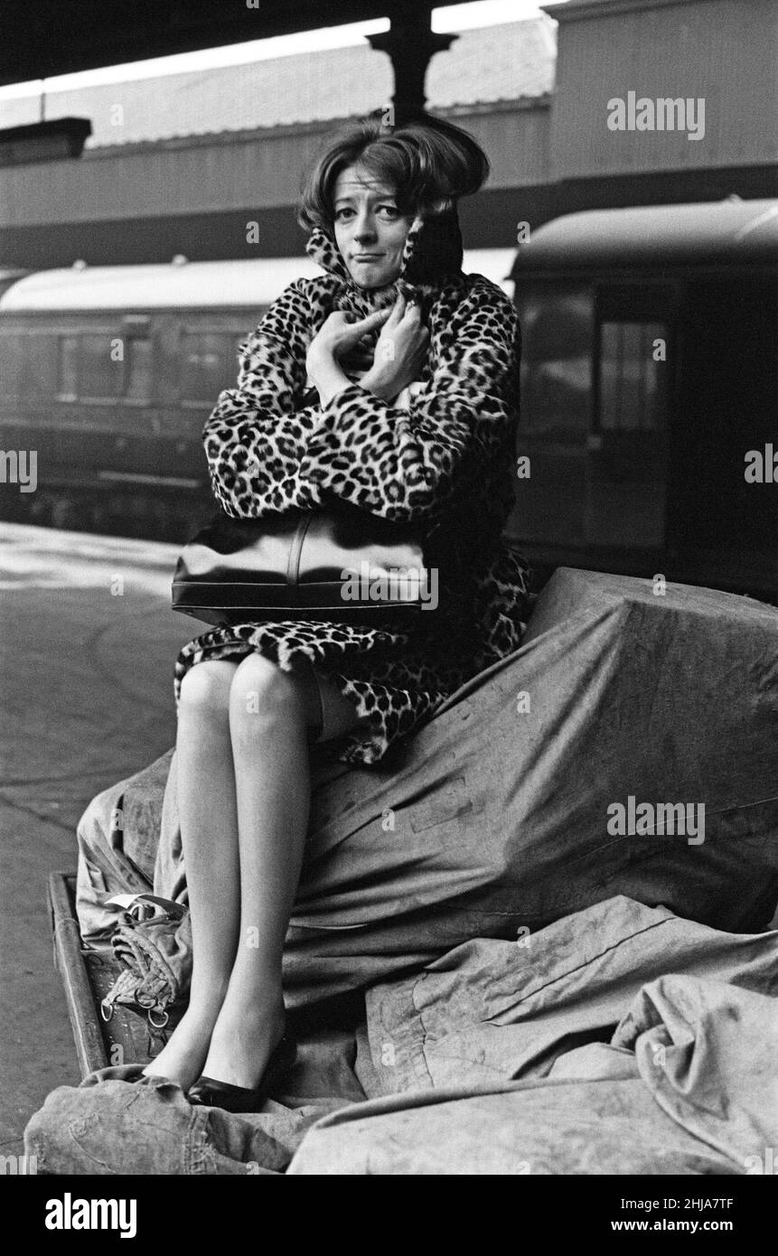 L'attrice Maggie Smith ha raffigurato su una piattaforma della stazione ferroviaria mentre attende un treno da Londra a Newcastle upon Tyne per provare con Sir Laurence Olivier per la produzione del Teatro Nazionale di Othello (che sarà a Birmingham). 24th marzo 1964. Foto Stock