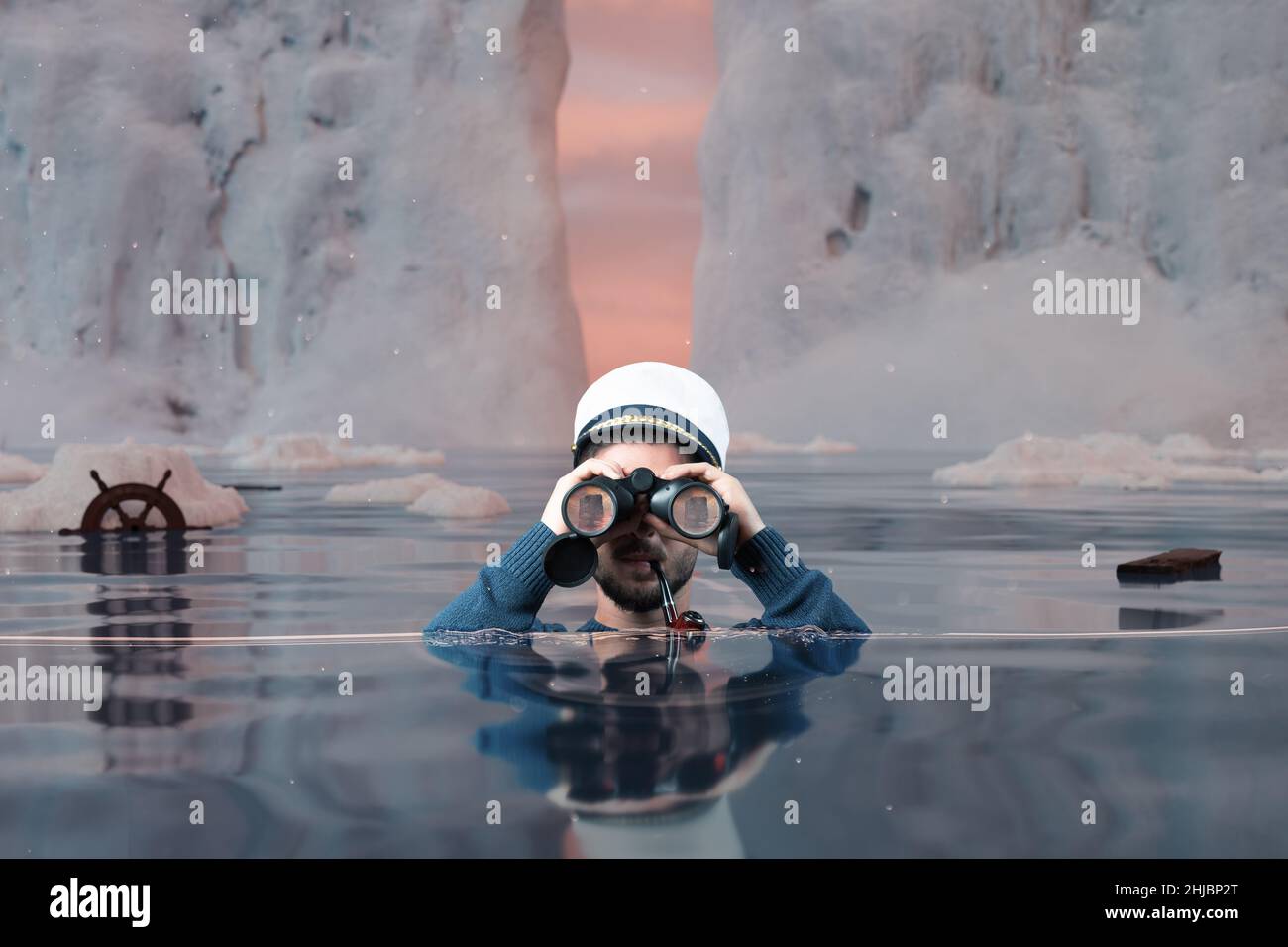 relitto timoniere in piedi sott'acqua e guardando con binocoli l'iceberg in alto mare Foto Stock