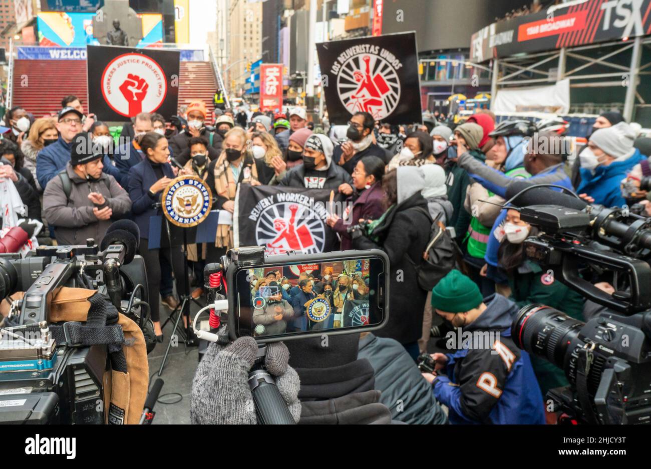 Il rappresentante Alexandria Ocasio-Cortez, centro, si unisce ai lavoratori di consegna, ai funzionari eletti e ai sostenitori di Times Square a New York domenica 23 gennaio 2022 per celebrare il passaggio nel Consiglio NYC di molteplici atti legislativi che garantiscono ai lavoratori di consegna l'accesso ai servizi igienici, la trasparenza dei guadagni e altri diritti umani. (© Richard B. Levine) Foto Stock