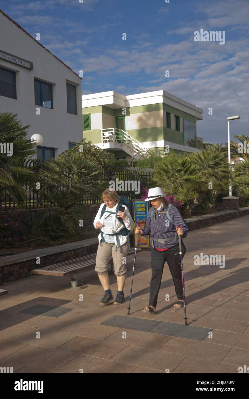 I turisti più anziani camminano lungo la passeggiata costiera a Playa de los Ingleses, Maspalomas, Gran Canaria, Spagna Foto Stock