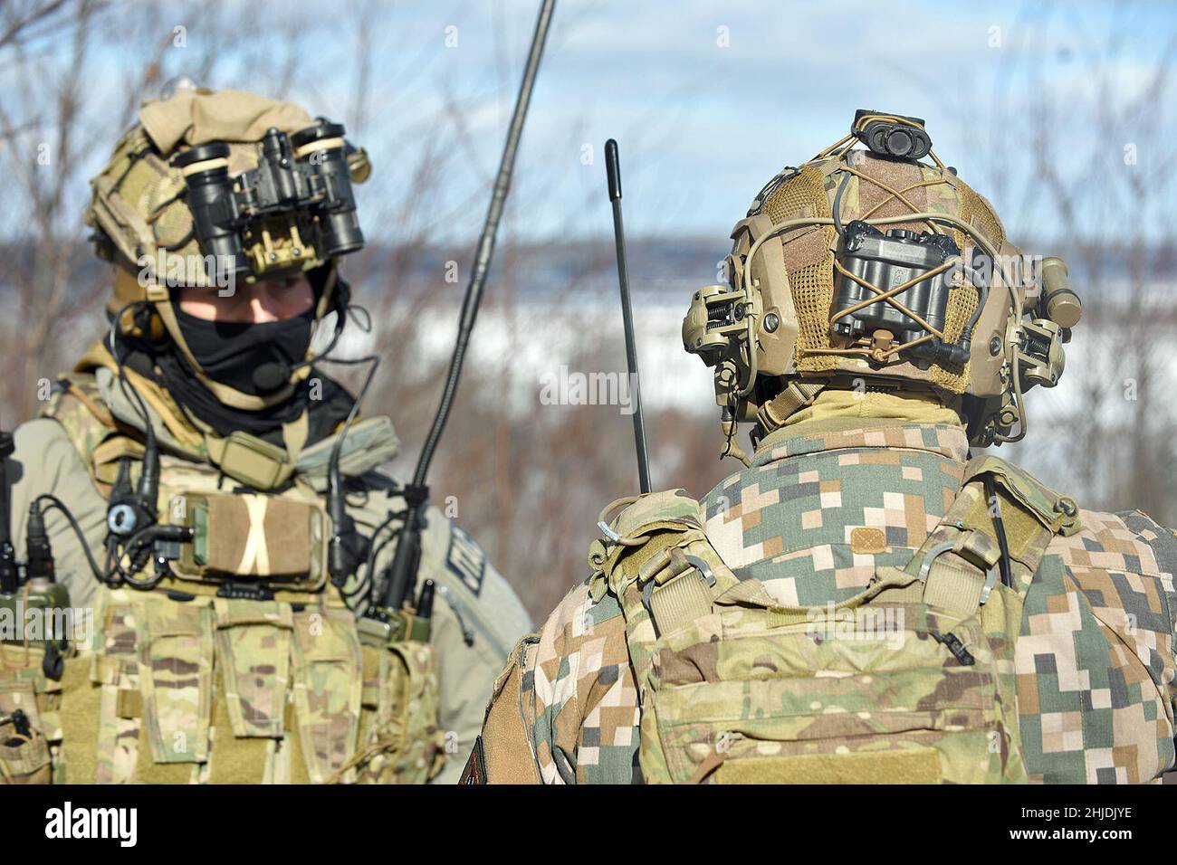 Il personale militare delle forze Armate nazionali lettoni lavora fianco a fianco con i soldati dell'esercito statunitense assegnati a Battery C, Battaglione 1st, reggimento dell'artiglieria da campo 120th, Guardia Nazionale dell'Esercito del Wisconsin, mentre conduce una stretta formazione di supporto aereo durante lo Sciopero settentrionale 22-1 ("Sciopero invernale") presso il National All-Domain Warfighting Center, Grayling, Michigan, gennaio 27, 2022. “Winter Strike”, l’iterazione invernale del programma di esercizi dello sciopero settentrionale, si svolge presso il National All-Domain Warwfighting Center del Michigan settentrionale. Il NADWC è il luogo perfetto per le unità del reparto DEF Foto Stock