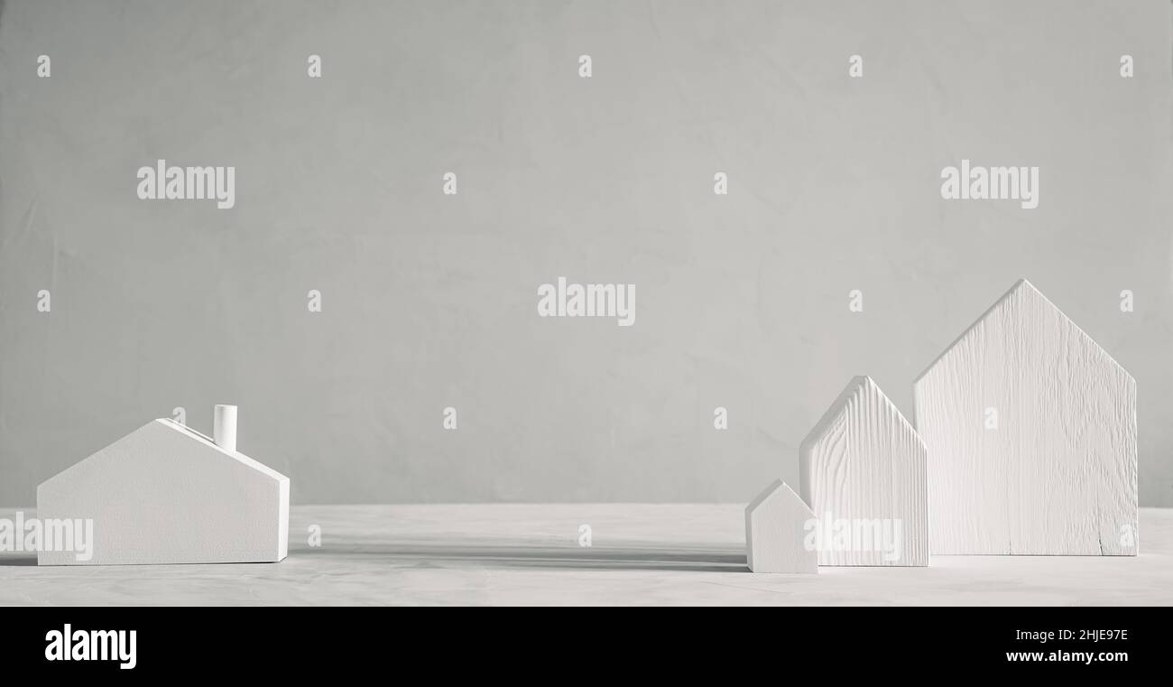 Case giocattolo bianche in legno su sfondo grigio. Design minimalista decorativo scandinavo Foto Stock