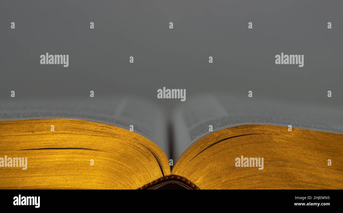 Primo piano di un vecchio libro aperto con pagine dorate, focalizzazione su primo piano e spazio di copia Foto Stock