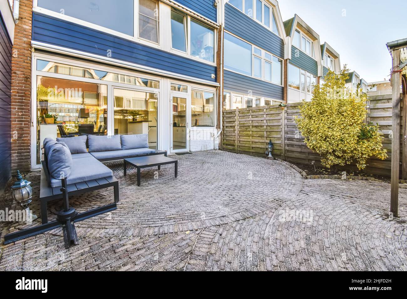 Incredibile cortile casa con enormi finestre con panca blu Foto Stock