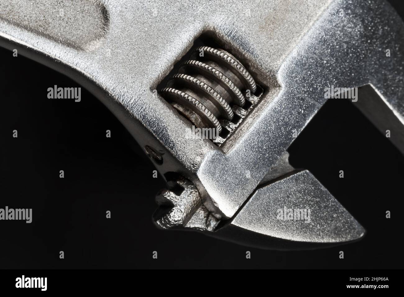 Meccanismo a vite senza fine di una chiave regolabile in primo piano su sfondo scuro Foto Stock