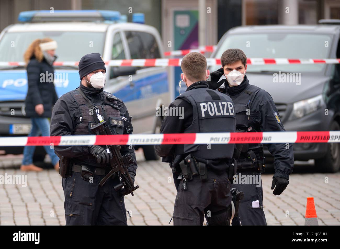 31 gennaio 2022, Schleswig-Holstein, Neumünster: Ufficiali di polizia si trovano di fronte alla stazione ferroviaria, ampiamente cordonata. A seguito di una minaccia di bomba, la stazione ferroviaria di Neumünster è stata chiusa lunedì mattina. Tuttavia, la chiusura è stata tolta dopo circa tre ore e mezza. Foto: Jonas Walzberg/dpa Foto Stock