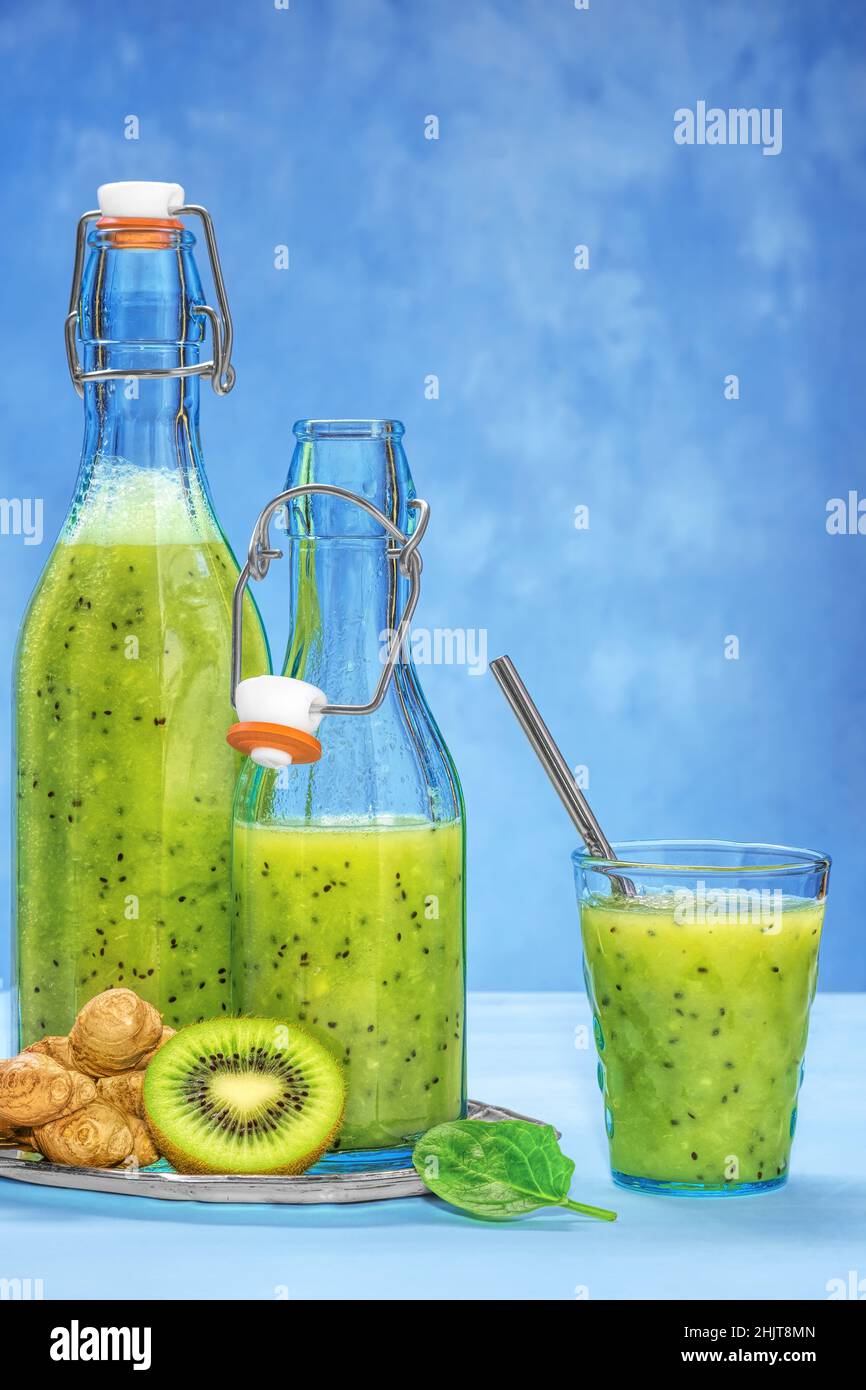 Bicchiere di spinaci verdi, arancia, zenzero e kiwi sani frullati. Foto Stock