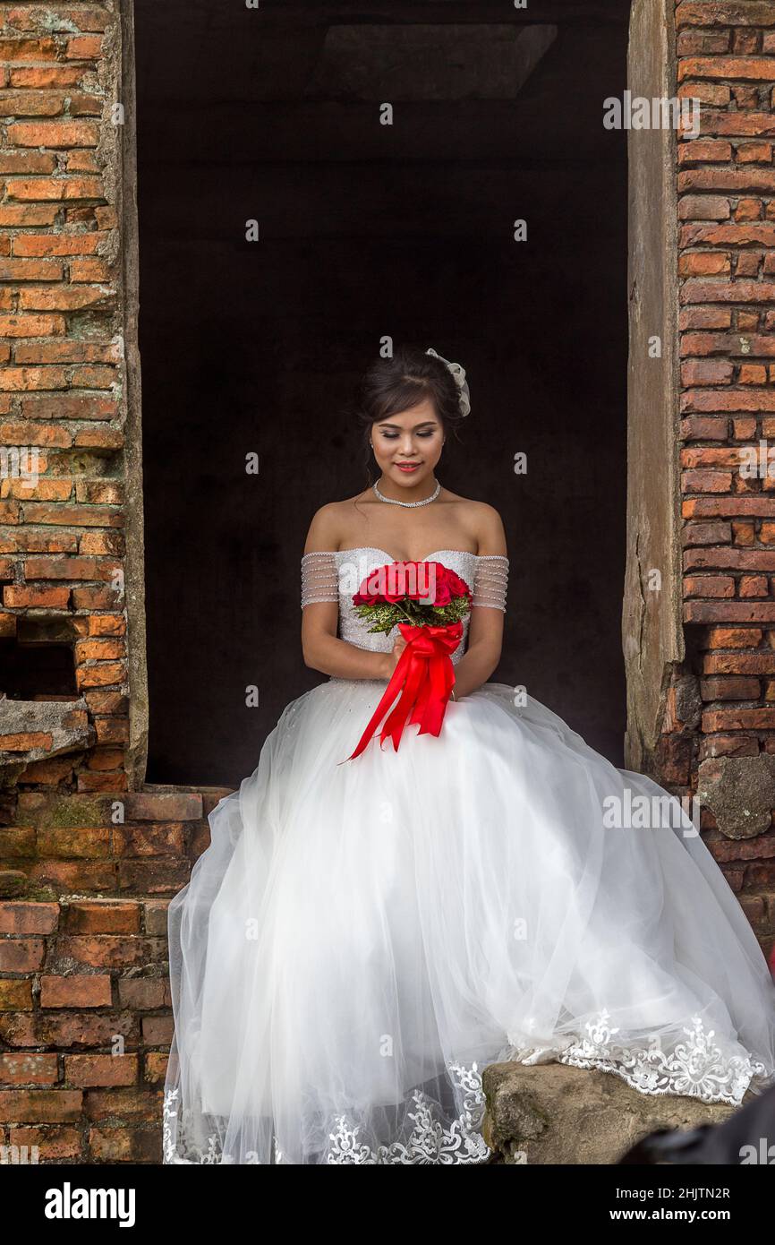 Una sposa si trova in un'area a porte aperte presso un'attrazione turistica, Hai Van Pass. Foto Stock