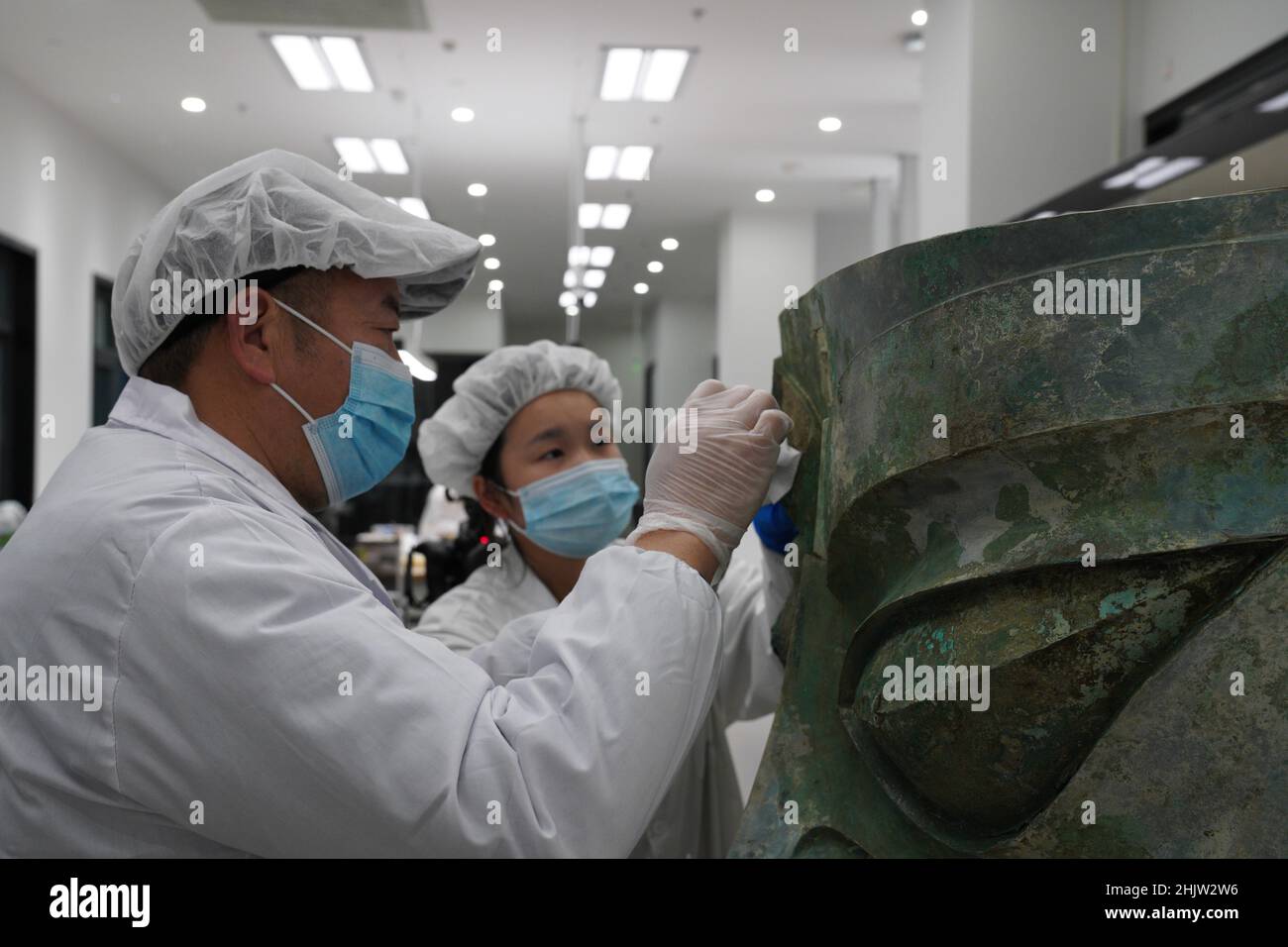 (220201) -- CHENGDU, 1 feb. 2022 (Xinhua) -- la foto mostra i membri del personale che riparano la maschera di bronzo scoperta presso il sito delle rovine di Sanxingdui nella provincia sudoccidentale del Sichuan della Cina. La maschera di bronzo più grande, che si è aperta dal leggendario sito delle rovine di Sanxingdui a Sichuan, ha incontrato il pubblico al Festival di primavera di lunedì TV Gala.The maschera misura 131 cm di larghezza, 71 cm di altezza e 66 cm di profondità, E pesa 65,5 kg, ha detto Tang Fei, capo del Sichuan Provincial Cultural Relics and Archaeology Research Institute. (Sichuan Provincial Cultural Relics and Archaeology Research Institute & Sanxingdui Museum/Handout via Xi Foto Stock