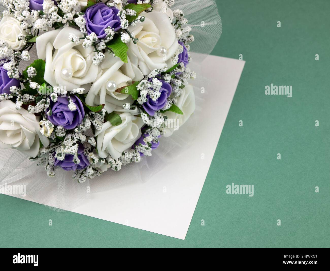 Bouquet di nozze con fiori artificiali su sfondo turchese con spazio copia. Concetto di biglietto di auguri o invito al matrimonio Foto Stock
